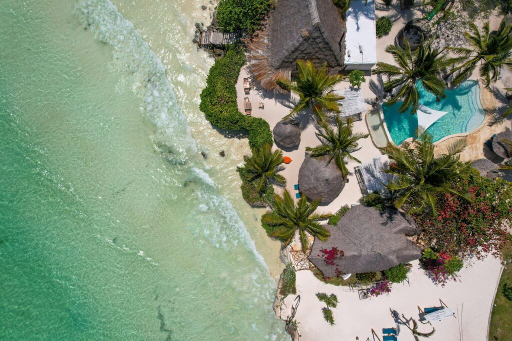 pexels-photo-14667295-14667295 Breathtaking aerial view of a tropical beach resort in Zanzibar with turquoise waters and palm trees.